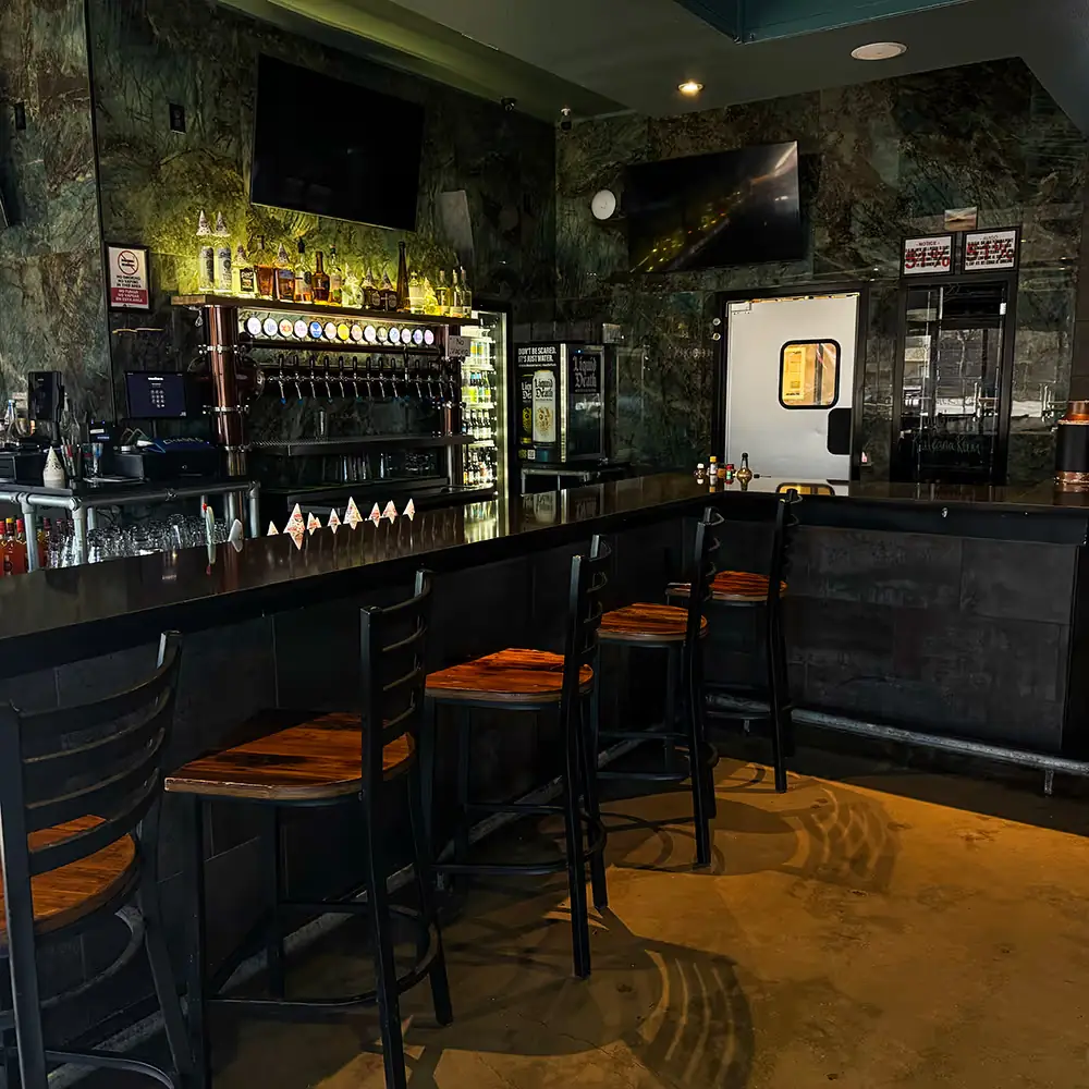 Bar stools facing the big screens at Lefty's sports bar in San Antonio
